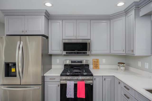 2941 Chapel Ln, Mount Pleasant, WI 53406 - kitchen featuring recessed lighting, light stone countertops, appliances with stainless steel finishes, and gray cabinetry