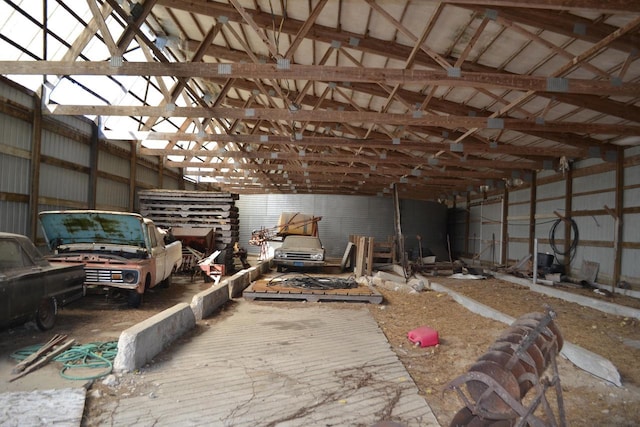 interior space featuring lofted ceiling and metal wall