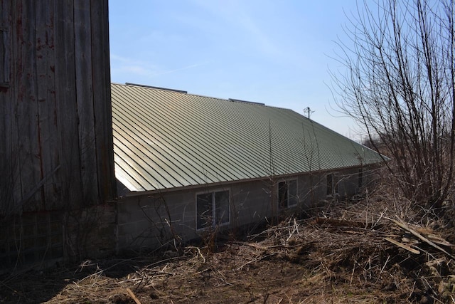 view of side of home featuring metal roof