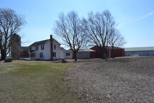 view of property exterior with a lawn and a chimney