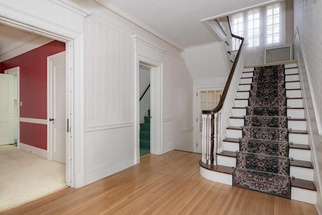 328 Wilson St, Winona, MN 55987 - staircase with crown molding and wood finished floors