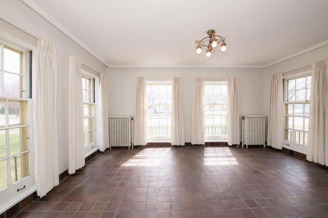 328 Wilson St, Winona, MN 55987 - empty room featuring plenty of natural light, an inviting chandelier, and radiator