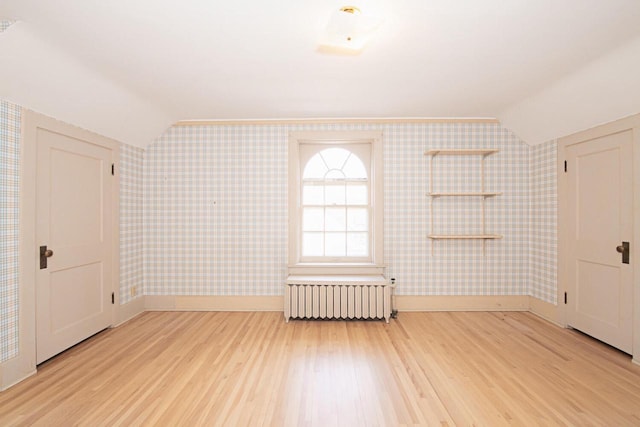 328 Wilson St, Winona, MN 55987 - bonus room with radiator, wallpapered walls, and lofted ceiling