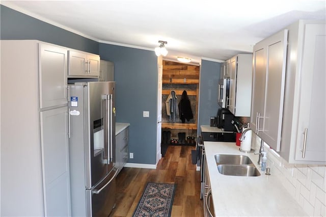 12188 Old Trl, Wisconsin Rapids, WI 54494 - kitchen featuring appliances with stainless steel finishes, light countertops, decorative backsplash, dark wood-type flooring, and crown molding
