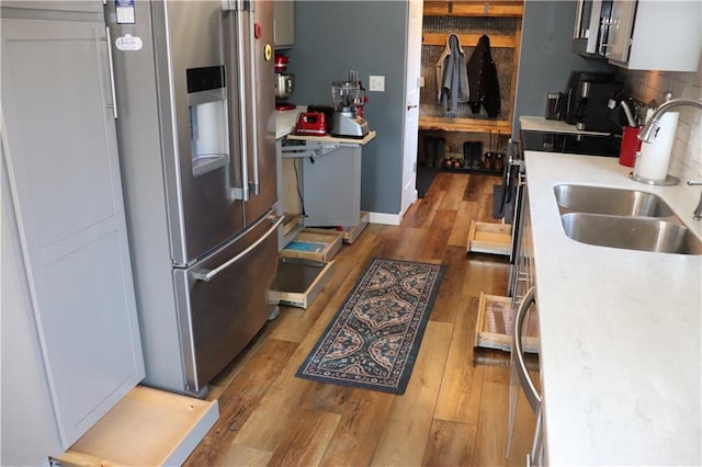 12188 Old Trl, Wisconsin Rapids, WI 54494 - kitchen featuring stainless steel refrigerator with ice dispenser, light wood-style floors, light countertops, range, and decorative backsplash