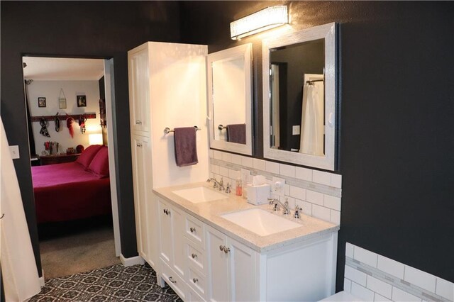 12188 Old Trl, Wisconsin Rapids, WI 54494 - ensuite bathroom featuring double vanity and backsplash