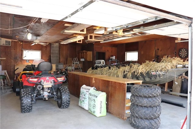 12188 Old Trl, Wisconsin Rapids, WI 54494 - garage featuring wood walls and a ceiling fan