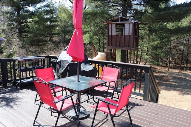 12188 Old Trl, Wisconsin Rapids, WI 54494 - deck with outdoor dining space and view of wooded area