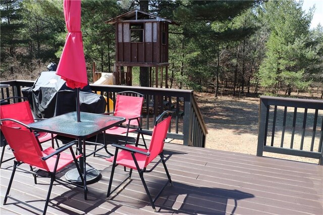 12188 Old Trl, Wisconsin Rapids, WI 54494 - wooden terrace featuring outdoor dining space and view of scattered trees