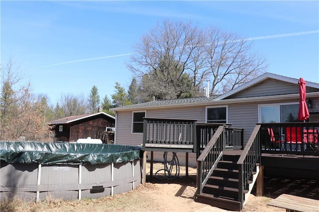 12188 Old Trl, Wisconsin Rapids, WI 54494 - rear view of property featuring a deck, a covered pool, stairs, and roof with shingles