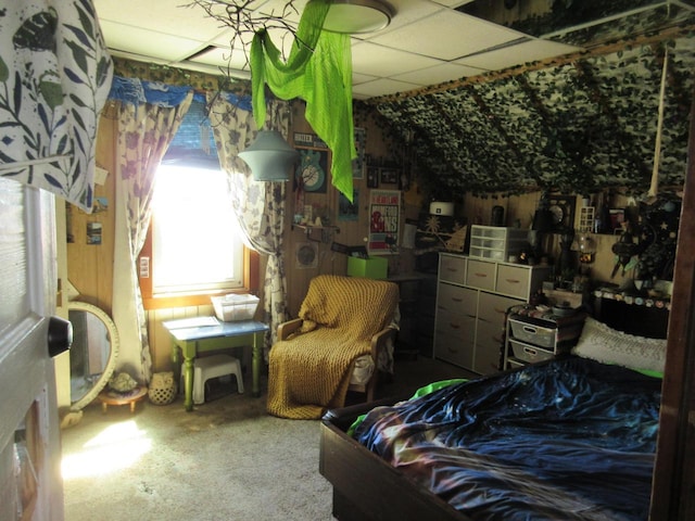 carpeted bedroom with a drop ceiling