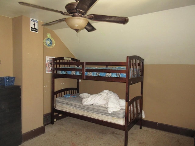 carpeted bedroom featuring baseboards, a ceiling fan, and lofted ceiling