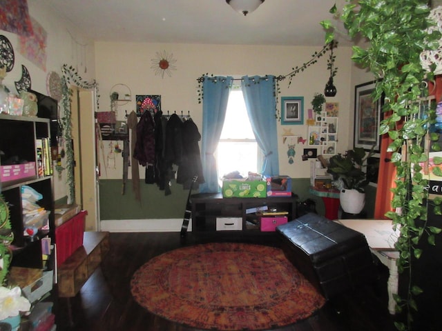 interior space featuring wood finished floors and baseboards