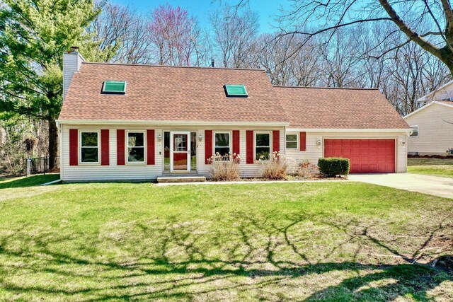 cape cod-style house with a chimney, a shingled roof, driveway, a front yard, and a garage
