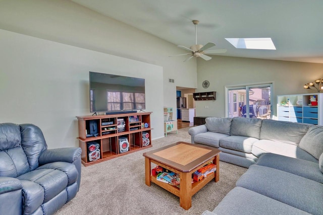 carpeted living area with high vaulted ceiling, ceiling fan, visible vents, and a skylight