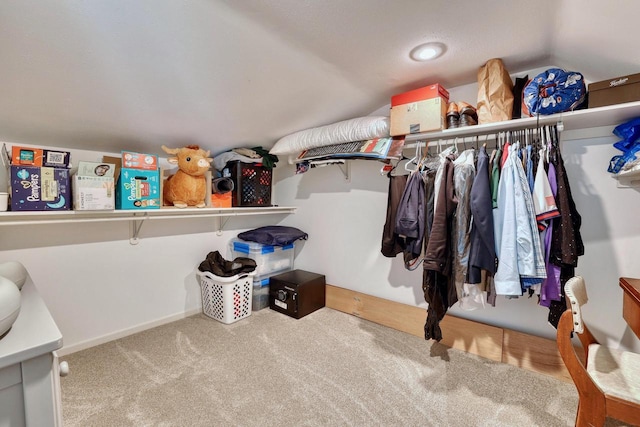 spacious closet with carpet and lofted ceiling