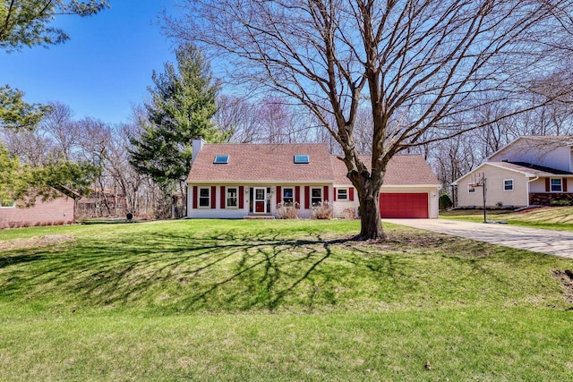 view of front of home with a chimney, a front lawn, driveway, and a garage