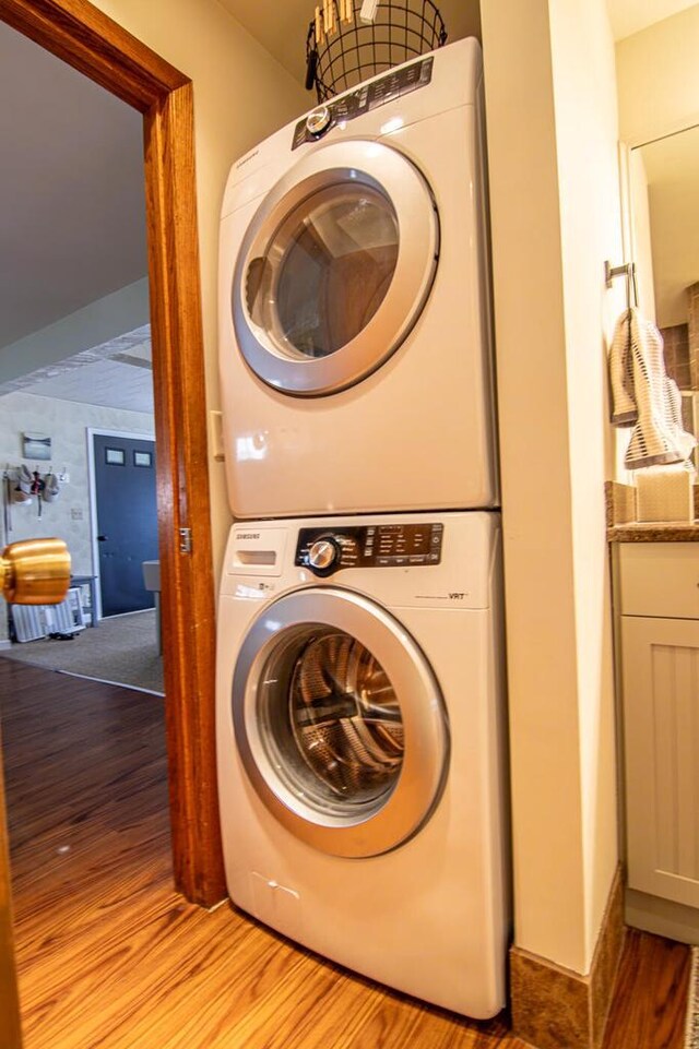 N4142 Sleepy Hollow Rd, Cambridge, WI 53523 - washroom featuring laundry area, stacked washer and dryer, and light wood finished floors