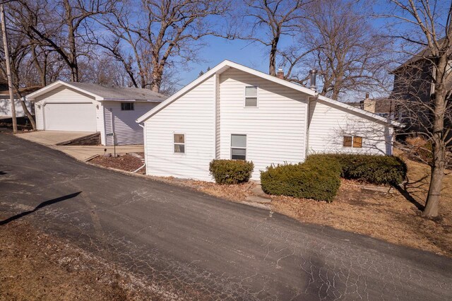 N4142 Sleepy Hollow Rd, Cambridge, WI 53523 - view of side of property featuring a garage, driveway, and an outdoor structure
