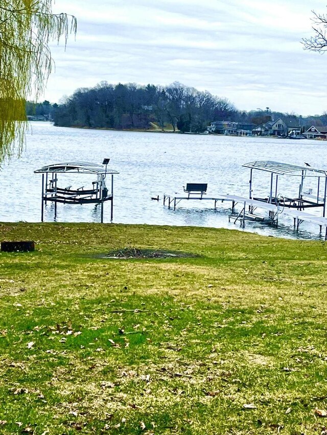 N4142 Sleepy Hollow Rd, Cambridge, WI 53523 - dock area featuring a lawn, a water view, and boat lift
