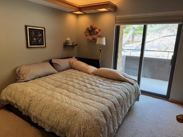 carpeted bedroom with access to exterior
