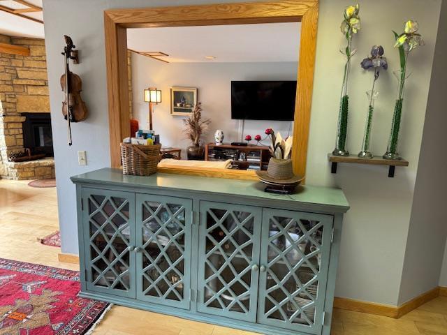 bar featuring a stone fireplace