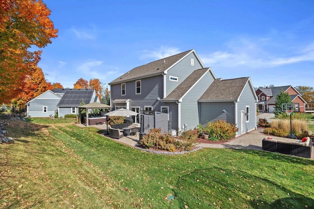 1549 Cambridge Ct, Hubertus, WI 53033 - back of house featuring a gazebo, a patio area, a lawn, and an outdoor living space