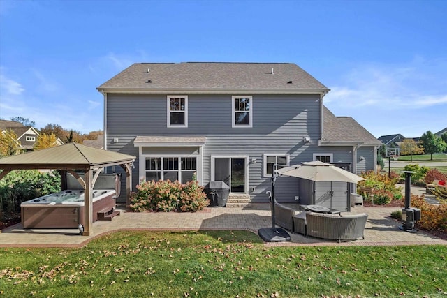 1549 Cambridge Ct, Hubertus, WI 53033 - back of property with entry steps, a yard, a patio area, a gazebo, and a hot tub