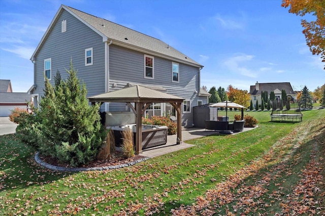 1549 Cambridge Ct, Hubertus, WI 53033 - rear view of property with a gazebo, a lawn, a hot tub, and a patio
