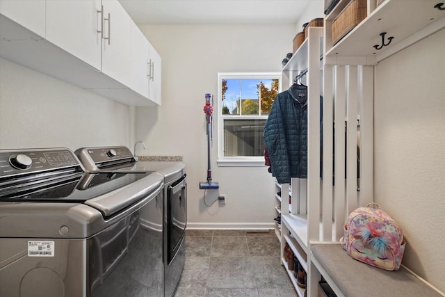 1549 Cambridge Ct, Hubertus, WI 53033 - clothes washing area with baseboards, cabinet space, and washer and clothes dryer