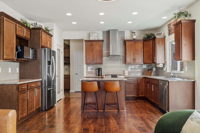 1549 Cambridge Ct, Hubertus, WI 53033 - kitchen featuring recessed lighting, wall chimney range hood, a sink, a kitchen island, and appliances with stainless steel finishes