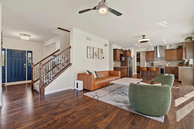 1549 Cambridge Ct, Hubertus, WI 53033 - living room featuring stairs, ceiling fan, visible vents, baseboards, and dark wood-style floors