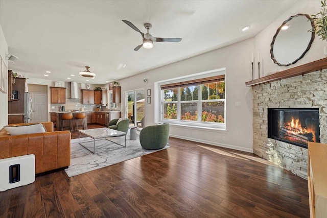 1549 Cambridge Ct, Hubertus, WI 53033 - living room with recessed lighting, ceiling fan, a stone fireplace, baseboards, and dark wood-style flooring