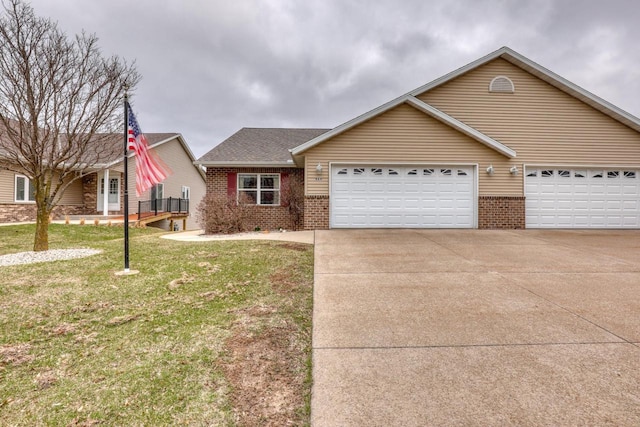 864 Chief Kewaskum Pl, Kewaskum, WI 53040 - view of front of home with an attached garage, brick siding, a front yard, and concrete driveway