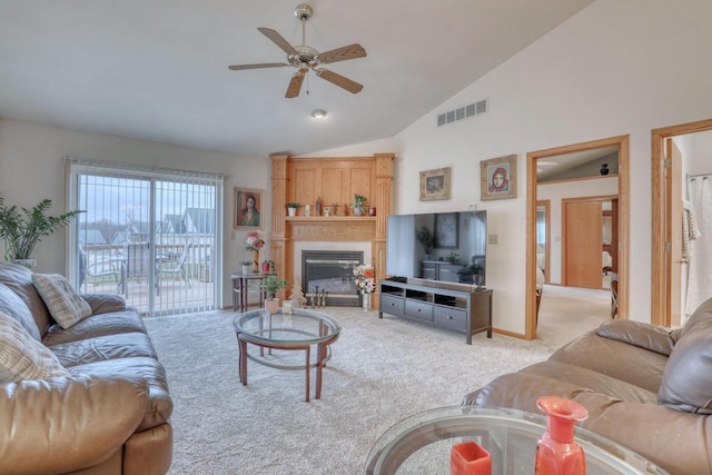 864 Chief Kewaskum Pl, Kewaskum, WI 53040 - carpeted living room featuring a glass covered fireplace, vaulted ceiling, visible vents, and ceiling fan