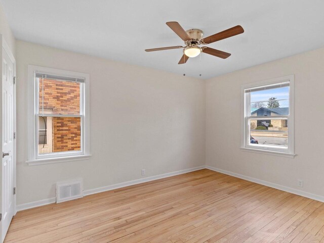 7509 W Burleigh St, Milwaukee, WI 53210 - unfurnished room featuring ceiling fan, baseboards, visible vents, and light wood-style flooring