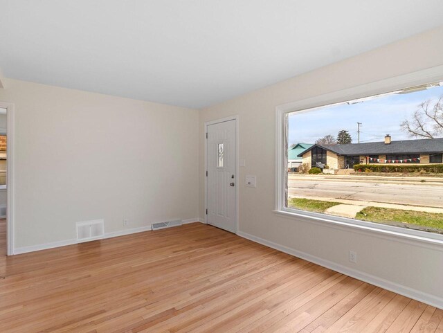 7509 W Burleigh St, Milwaukee, WI 53210 - entryway with baseboards, visible vents, and light wood-style flooring