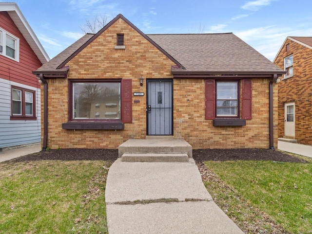 7509 W Burleigh St, Milwaukee, WI 53210 - view of front of house with a front yard, roof with shingles, and brick siding
