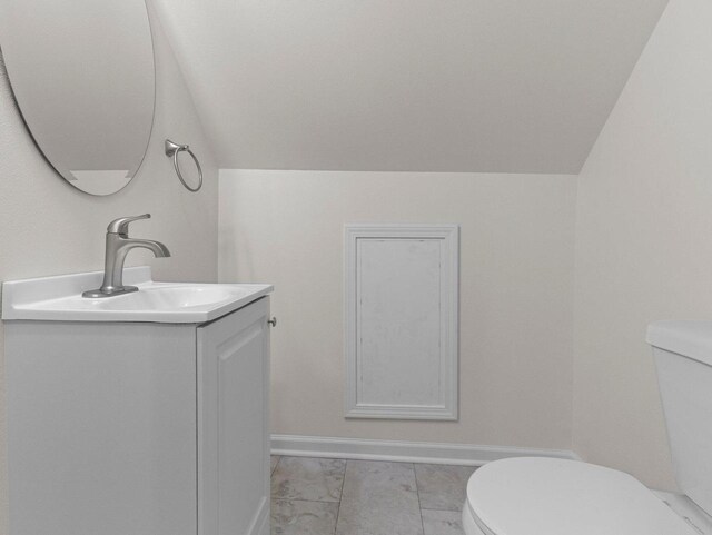 7509 W Burleigh St, Milwaukee, WI 53210 - half bathroom with marble finish floor, lofted ceiling, toilet, and vanity
