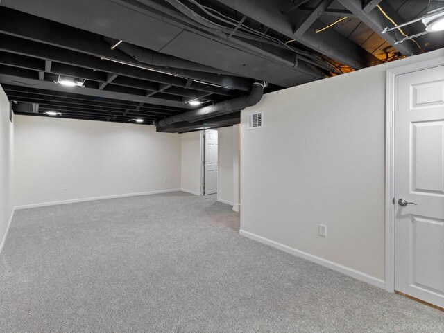 7509 W Burleigh St, Milwaukee, WI 53210 - finished below grade area featuring carpet floors, visible vents, and baseboards