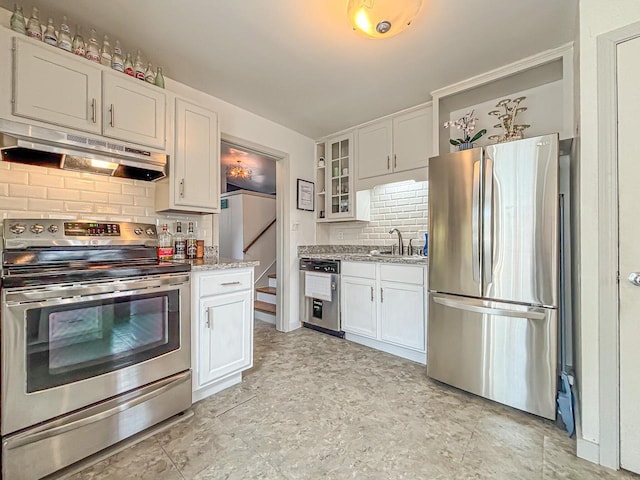 825 Post Rd, Brookfield, WI 53005 - kitchen with a sink, white cabinetry, decorative backsplash, under cabinet range hood, and appliances with stainless steel finishes