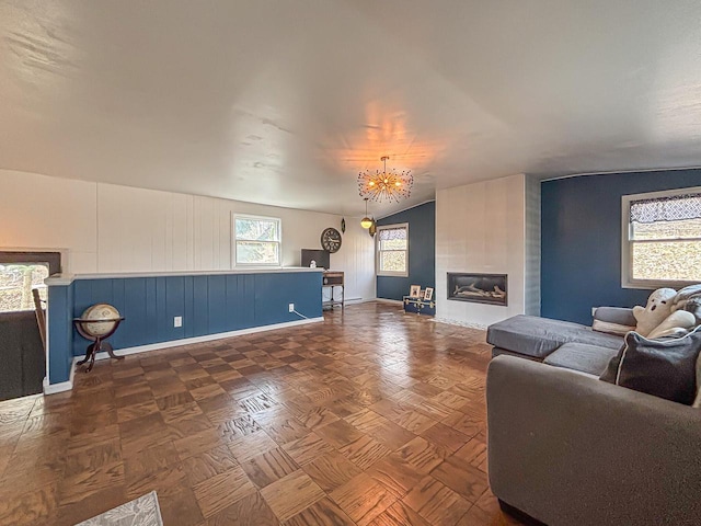 825 Post Rd, Brookfield, WI 53005 - living room featuring a chandelier, a tiled fireplace, and baseboards