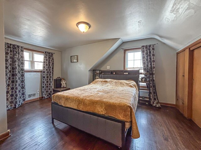 825 Post Rd, Brookfield, WI 53005 - bedroom featuring vaulted ceiling, hardwood / wood-style floors, visible vents, and multiple windows