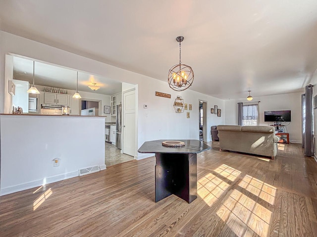 825 Post Rd, Brookfield, WI 53005 - interior space featuring visible vents, baseboards, wood finished floors, and an inviting chandelier