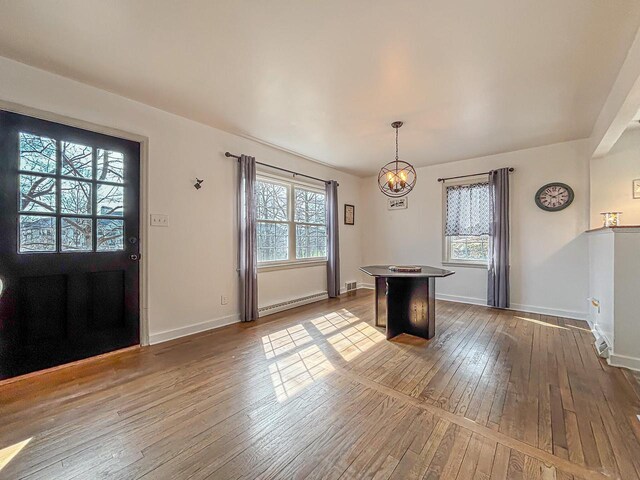 825 Post Rd, Brookfield, WI 53005 - unfurnished dining area with baseboards, hardwood / wood-style flooring, baseboard heating, and an inviting chandelier