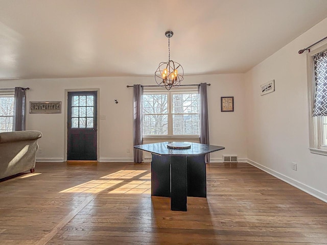 825 Post Rd, Brookfield, WI 53005 - unfurnished dining area with a chandelier, baseboards, visible vents, and dark wood-type flooring