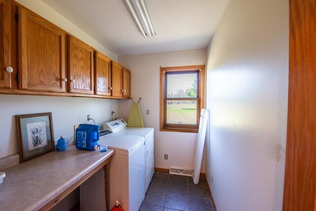 9506 296th Ave, Salem, WI 53168 - washroom featuring tile patterned flooring, visible vents, baseboards, separate washer and dryer, and cabinet space