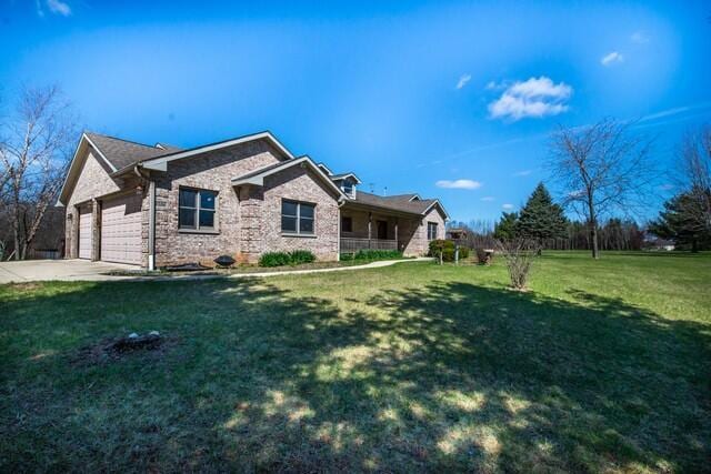 9506 296th Ave, Salem, WI 53168 - exterior space featuring an attached garage, driveway, a front lawn, and covered porch