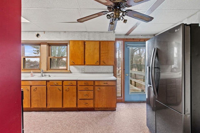 771 Seneca Rd, Wisconsin Rapids, WI 54495 - kitchen with brown cabinetry, stainless steel fridge with ice dispenser, a sink, and light countertops