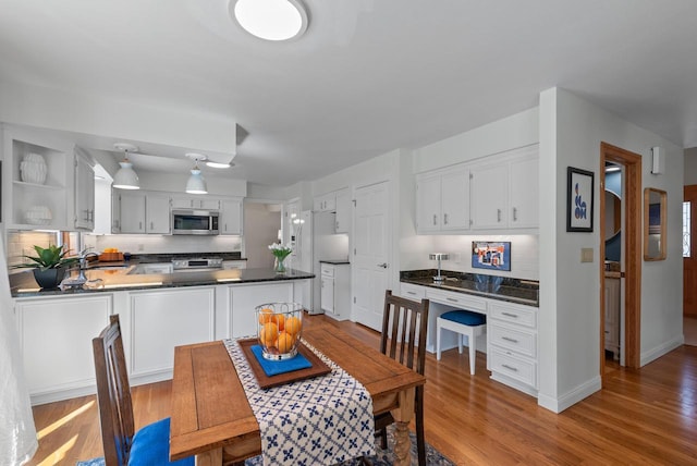 dining area with light wood finished floors and baseboards